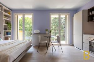 a bedroom with a bed and a table and chairs at BePlace Apartments at Fondazione Prada in Milan