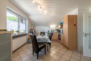 a kitchen with a table and chairs in a room at Ferienwohnung Am Steinchen in Mettlach