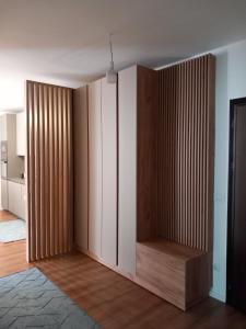 a room with white cabinets and wood dividers at Banesa ne qender te Pejes 2 in Peje