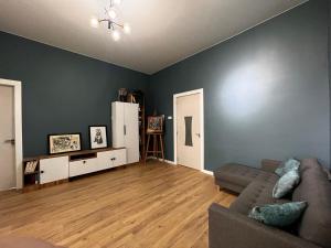 a living room with a couch and a hard wood floor at Mziuri Guest House in Gonio