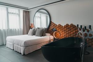 A bed or beds in a room at Poem Apartments, Las Canteras