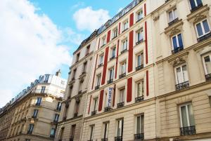 a large building with red and white windows at Hôtel Avenir Jonquière in Paris +19 photos
