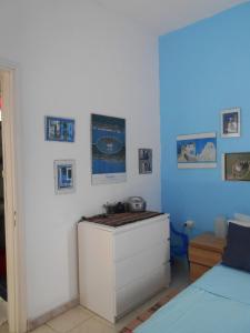 a room with a white cabinet and a blue wall at Meltemia Studio Samos No6 Pefkos in Votsalákia