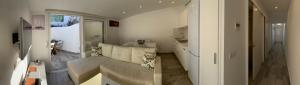 a living room with a couch and a kitchen at Luxury oceanfront villa in an idyllic location no1 in Cala'n Bosch +169 photos