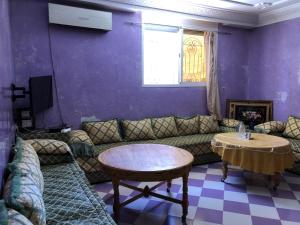 a living room with a couch and a table at Appartement Meublé à Louer 95m2 in Tiznit