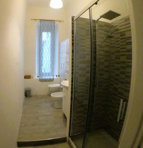 a bathroom with a shower and a toilet and a window at Casa Vacanze Trieste Piace in Trieste