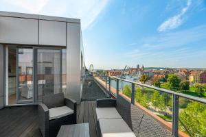 a balcony with a view of the city at Blue Mandarin Riverside in Gdańsk
