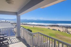a balcony with a view of the beach at Point Village Accommodation - Linda in Mossel Bay