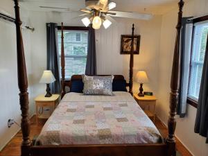 a bedroom with a bed with a ceiling fan and two lamps at 3864 Walsh Street Apartment in Jacksonville