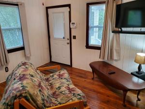 a living room with a couch and a table and a tv at 3864 Walsh Street Apartment in Jacksonville