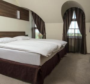 a bedroom with a large bed and a window at Hotel Duchess in Varna City