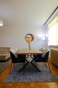 a dining room with a table and chairs at BLOK apartment in Visoko