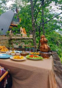 a table with plates of food on top of it at Zayna bungalov in Çamlıhemşin