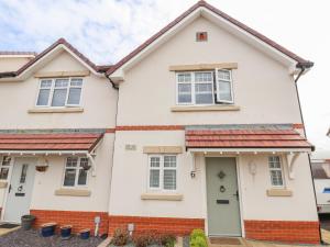 a white house with red bricks at 6 Cwrt Griffiths in Rhyl