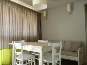 a dining room table and chairs with a couch at VVF Île de Ré Sainte-Marie-de-Ré in Sainte-Marie-de-Ré +24 photos
