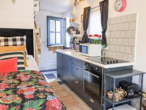 a kitchen with a counter and a stove in a room at Creed Cabin in Stornoway