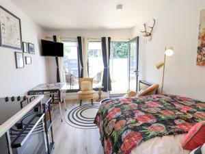a bedroom with a bed and a desk with a television at Creed Cabin in Stornoway