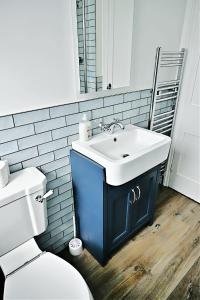 een badkamer met een witte wastafel en een toilet bij Porthmadog, Sleeps 11, 5 Bedrooms, 5 Bathrooms, Mountain Views in Porthmadog