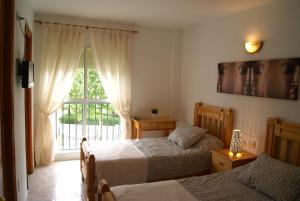 Postel nebo postele na pokoji v ubytování Hostal Sango Sierra de las Nieves