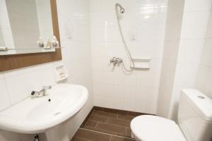 a white bathroom with a sink and a toilet at La Luna in Kala Nera +34 photos