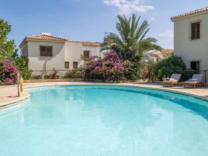 a swimming pool in front of a house at Cute & Cozy Mazotos 1bed Getaway in Mazotos