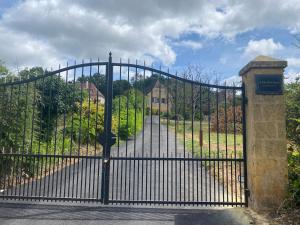 a black gate with a road behind it at Le Clos Saint James 5 étoiles in Domme +62 photos