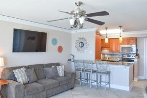 a living room with a couch and a kitchen at Dolphin Run in Virginia Beach
