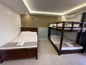 a room with two bunk beds in a hostel at Spotlight Hotel in Alaminos