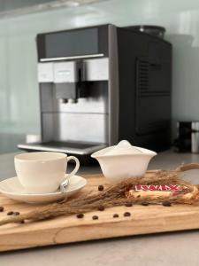 a counter with two cups and a coffee maker at Appartement Lena in Linz