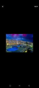 una pantalla de televisión con una foto de una piscina en Wndyham kuşadasi 1+1 teraslı 2 banyo dublex en Aydın