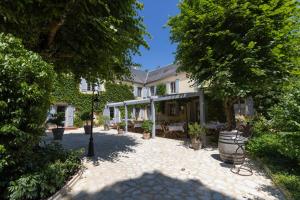 a courtyard of a house with trees and a street light at Le Moulin de Mitou in Auriac-du-Périgord +52 photos
