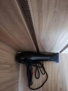 a black hair dryer sitting on top of a wooden floor at Sweet House Rabati in Akhaltsikhe