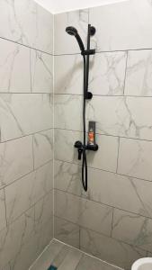 a shower with a black shower head in a bathroom at Aparthotel Residence in Vienna