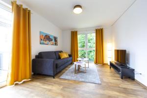 a living room with a couch and a table at Ferienwohnungen Rhönhimmel in Gersfeld