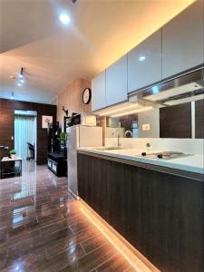 a kitchen with a refrigerator and a counter top at Air Residences Airbnb in Manila