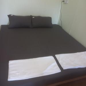 Ένα ή περισσότερα κρεβάτια σε δωμάτιο στο บ้านอิ่มเอม