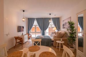 a living room with a couch and a bed and a table at ApartOne Altstadt-Apartments in Bautzen