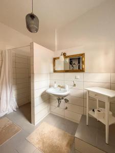 a bathroom with a sink and a mirror at ApartOne Altstadt-Apartments in Bautzen