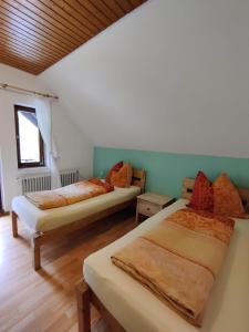 a room with two beds in a room at Berggasthaus Präger Böden in Todtnau