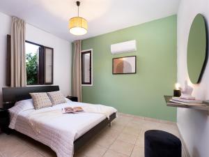 a bedroom with a bed and a green wall at Cute & Cozy Mazotos 1bed Getaway in Mazotos +4 photos