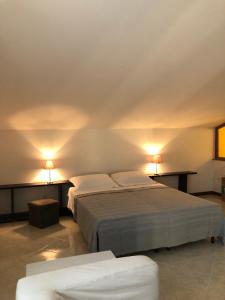 - 2 lits dans une chambre avec 2 lampes sur le mur dans l'établissement Hotel Kristall, à Orvieto