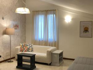 a living room with a couch and a window at Hotel Kristall in Orvieto