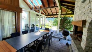 a dining room with a table and chairs and a fireplace at Luxuriöse Villa Romantica in Gampel