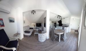 a living room with a table and a dining room at La colombe in Argelès-sur-Mer