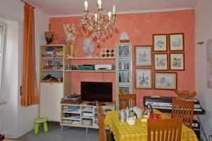 a dining room with a table with a television at La Porta delle 5 Terre Trilocali in Bonassola