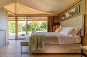 a bedroom with a large bed in a tent at Infinito Resort in Specchiolla 