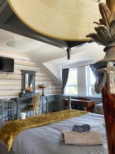 a bedroom with a large bed with a yellow blanket at Dulrush Lodge Guest House, Restaurant and Self-Catering in Belleek