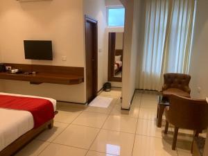 a hotel room with a bed and a desk and a chair at JESTA RESIDENCY in Hassan