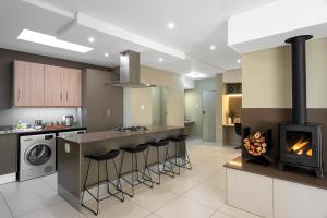 a kitchen with a stove and a fireplace at CAG The Hub Bryanston in Johannesburg
