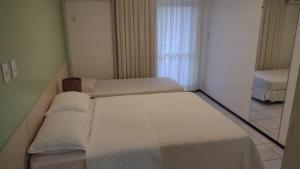 Ένα ή περισσότερα κρεβάτια σε δωμάτιο στο Gran Lençóis Flat